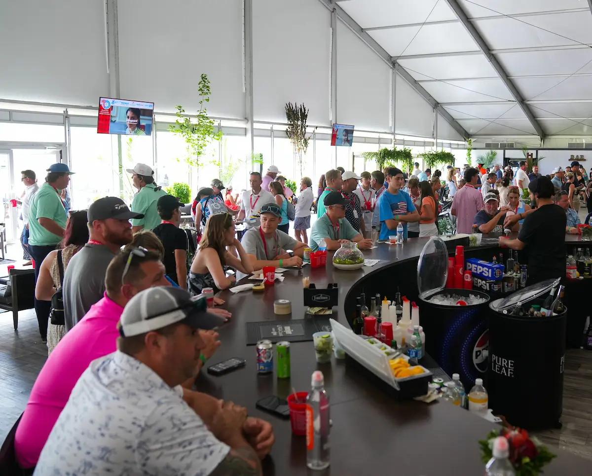 large group of people under a viewing tent