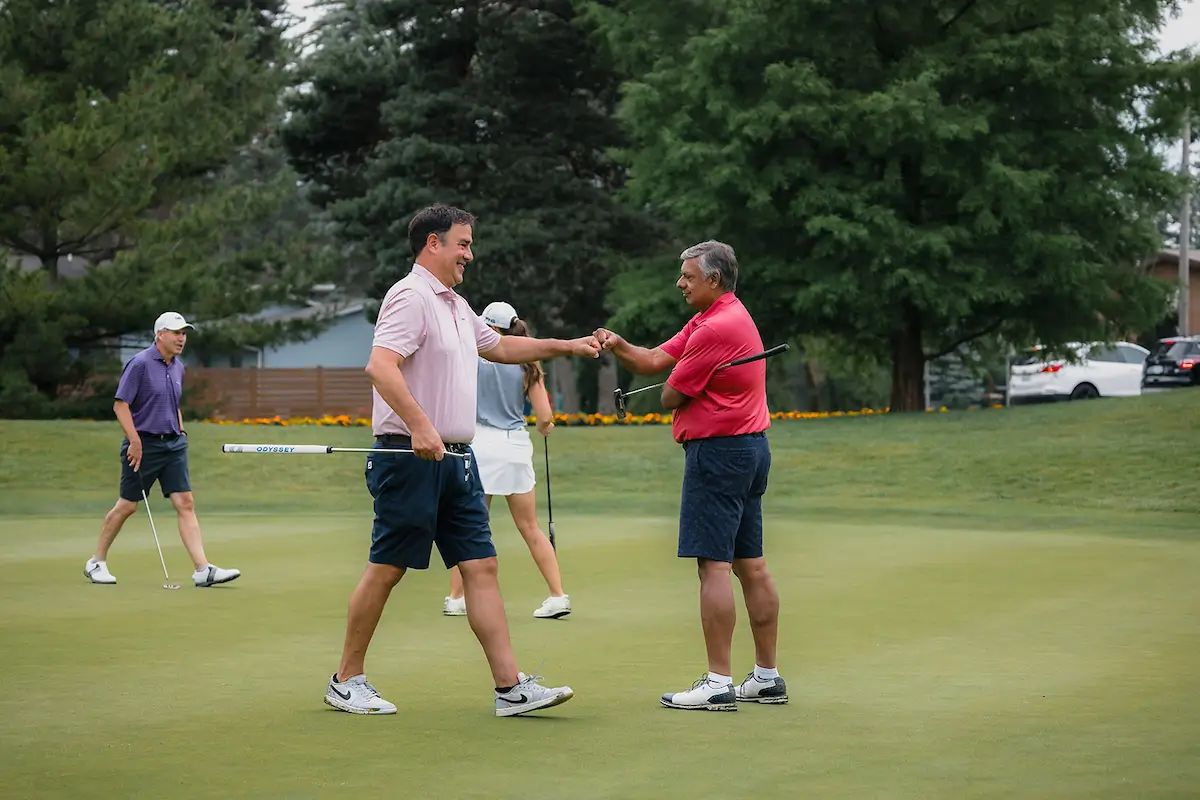 Two male golfers on the green