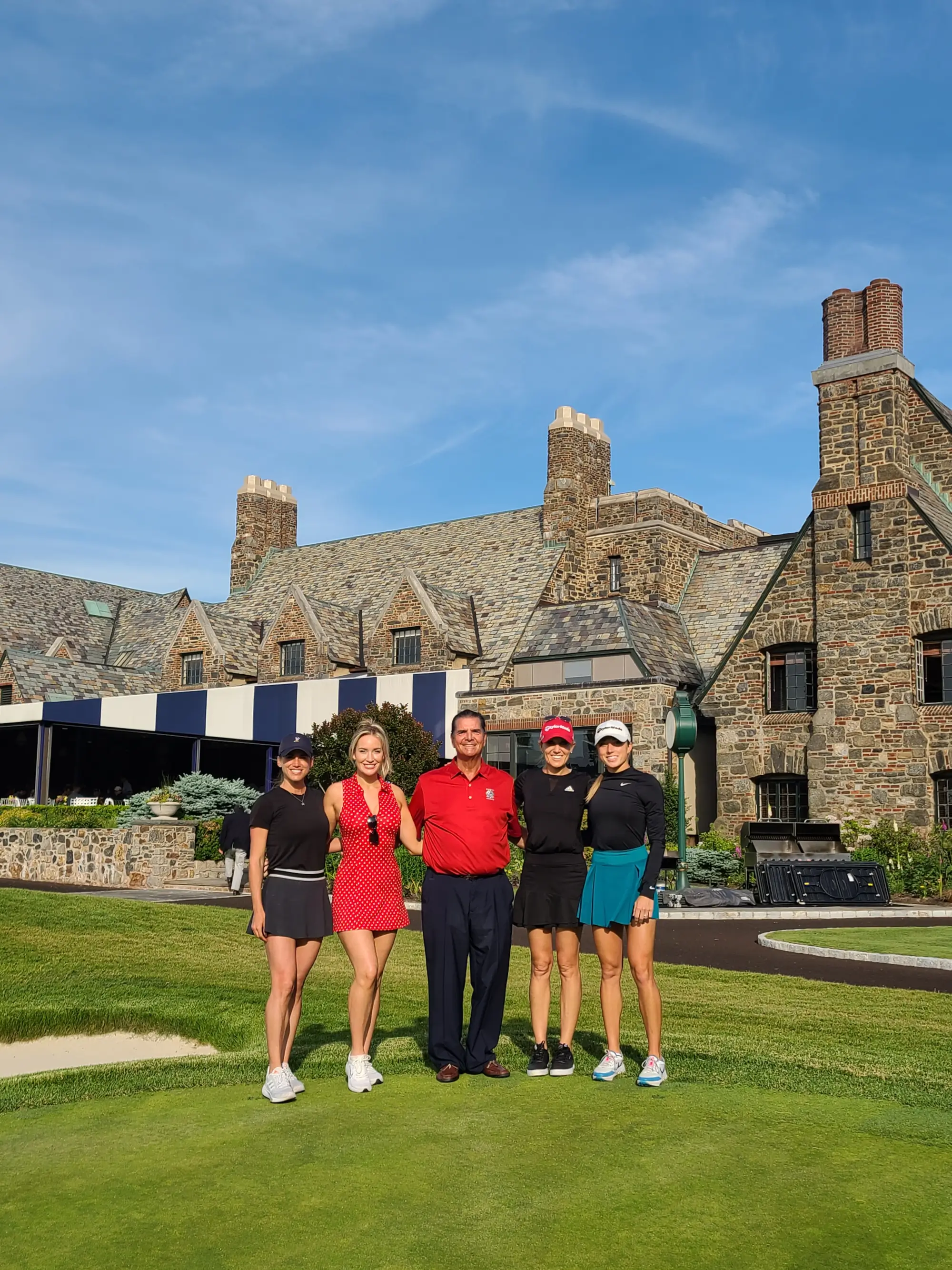 Men and Women posing on golf green for a photo