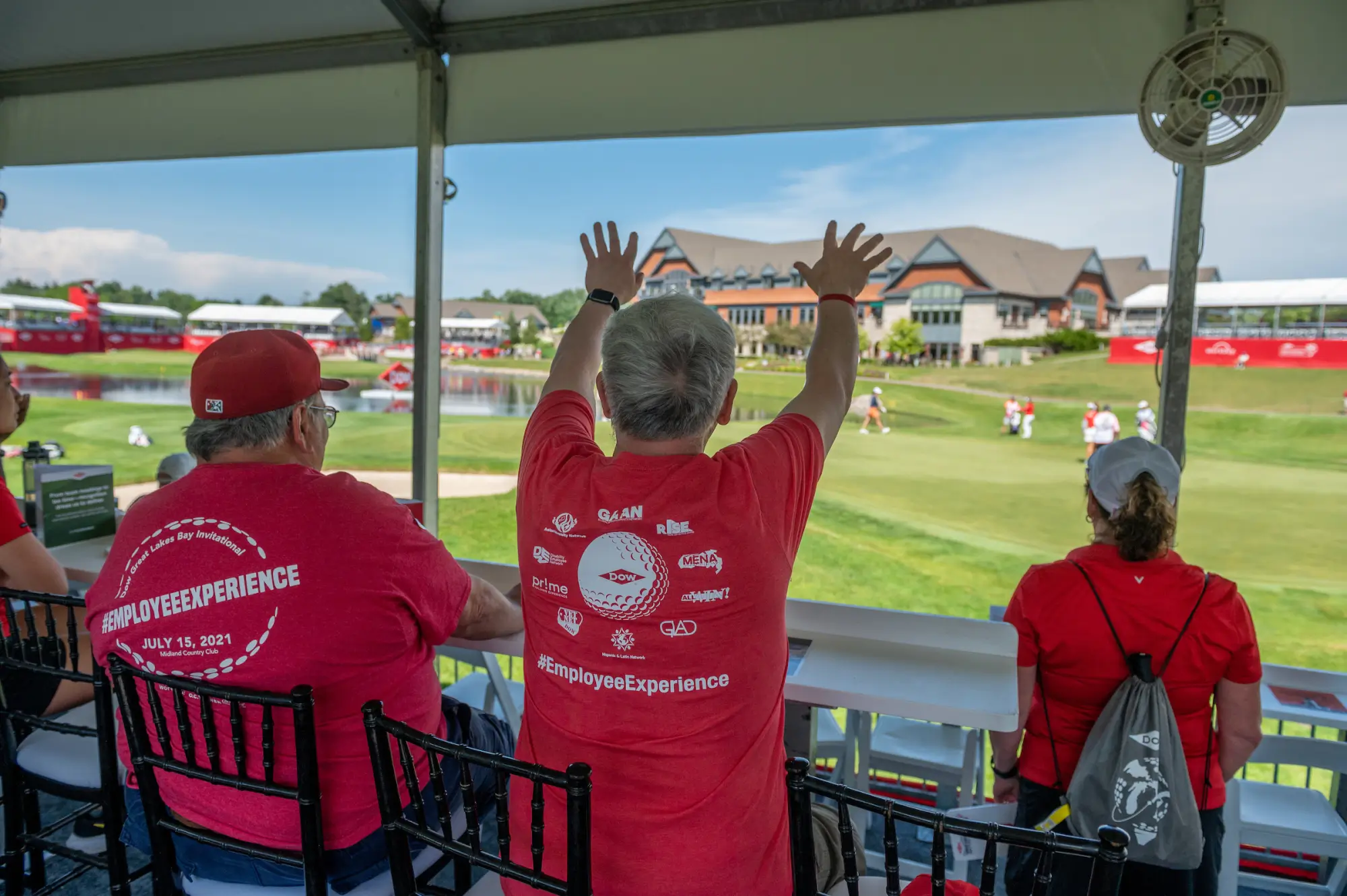 Fans in red shirts watching golf